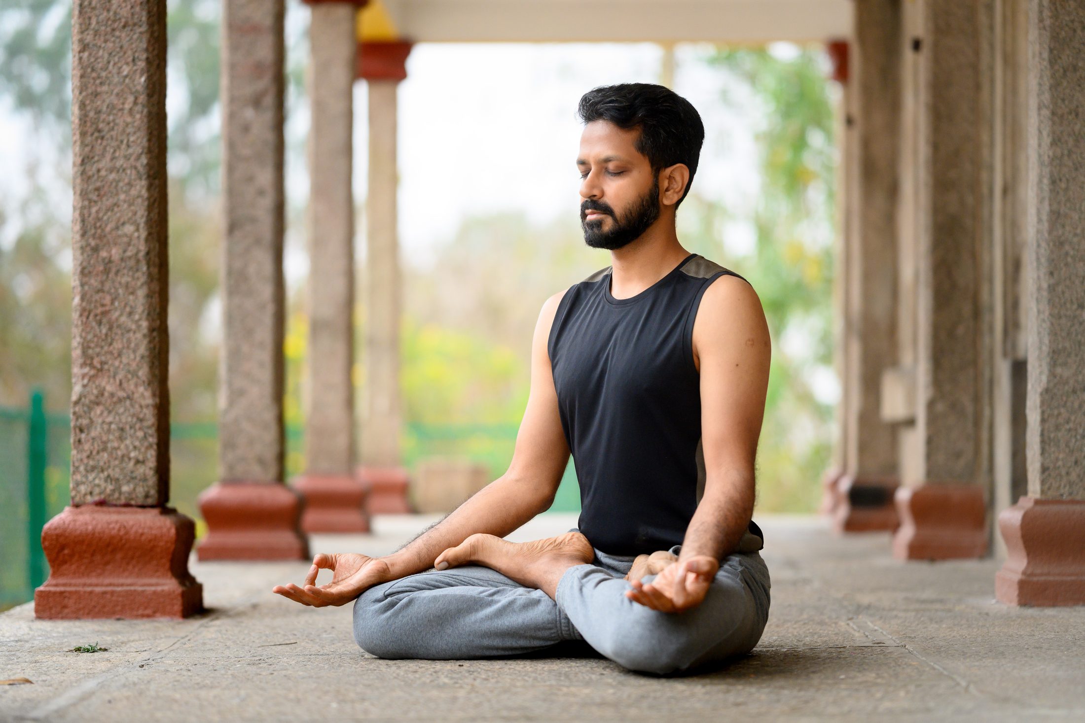 Ankur Bhati meditating between temple pillars