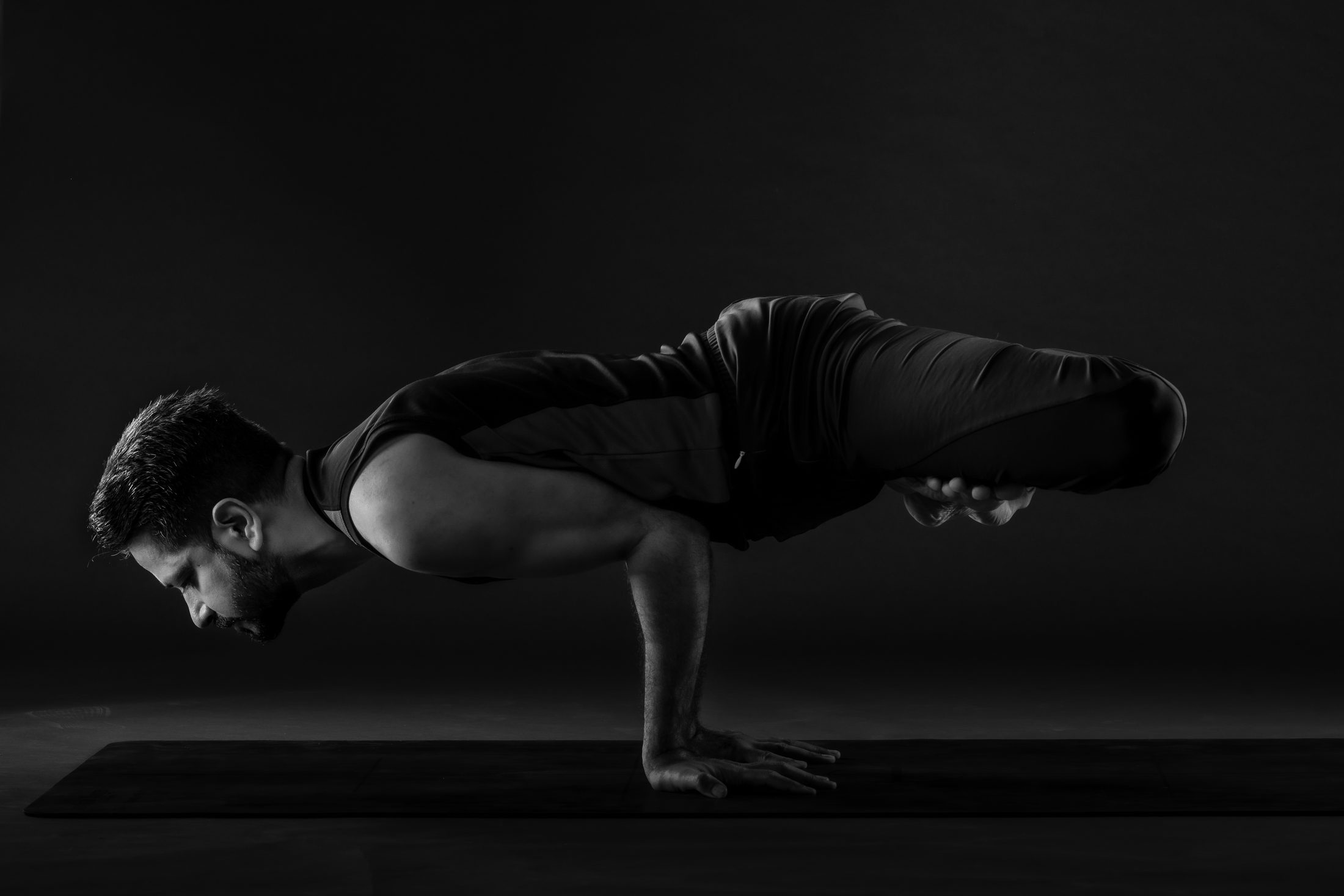 Ankur Bhati practising an arm balance in the studio