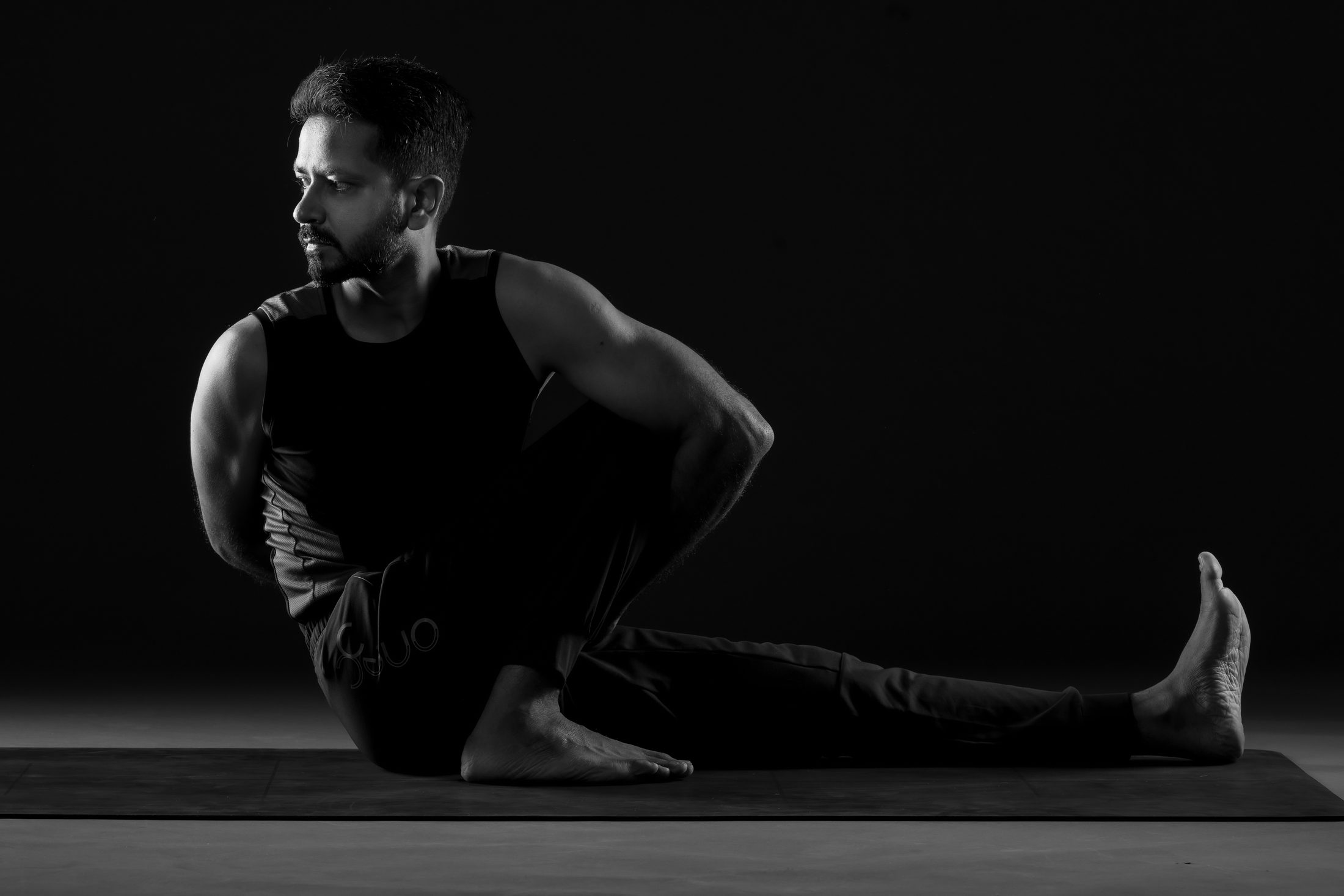 Ankur Bhati demonstrating a seated twist in the studio